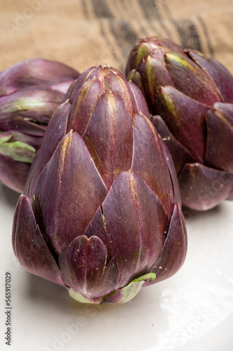 Heads of raw fresh purple mini romanesco artichoke vegetable ready to cook