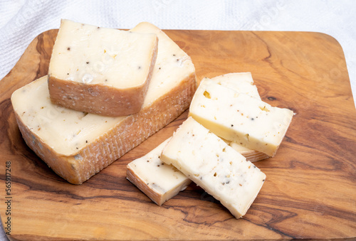 Italian cheese collection, yellow taleggio cheese with black truffles mushrooms