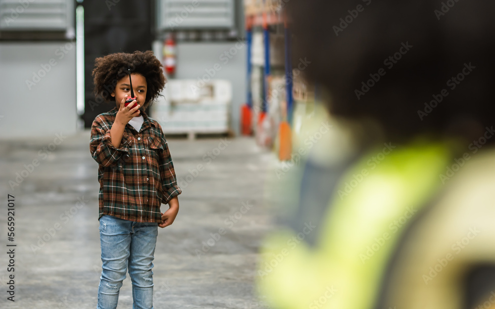 Selective focus, portrait happy little boy wearing casual check shirt, using walkie talkie, playing in factory with fun, dreaming to be engineer. Education Concept.