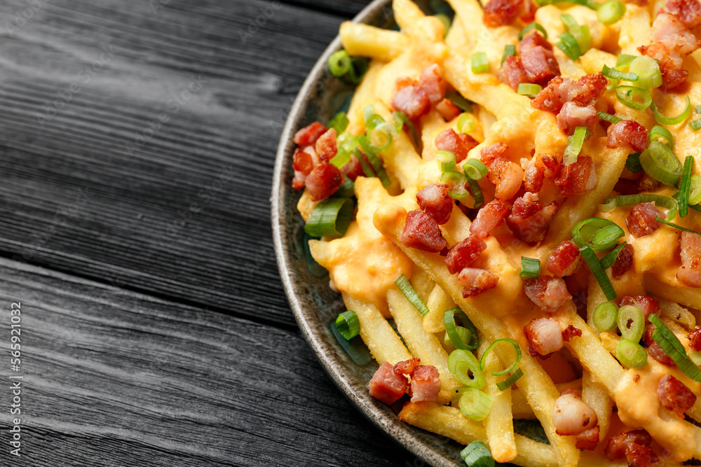 Crispy French fries loaded with bacon, cheese sauce and spring onion Crispy French fries loaded with bacon, cheese sauce and spring onion