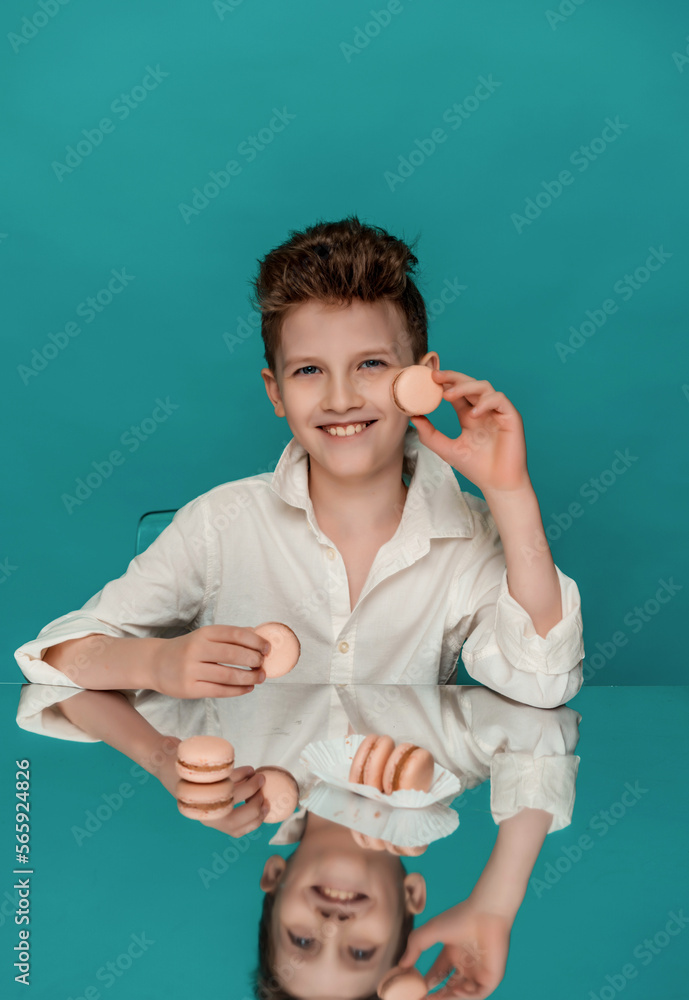 studio portrait of a boy on a blue background with sweets studio portrait of a boy on a blue background with sweets