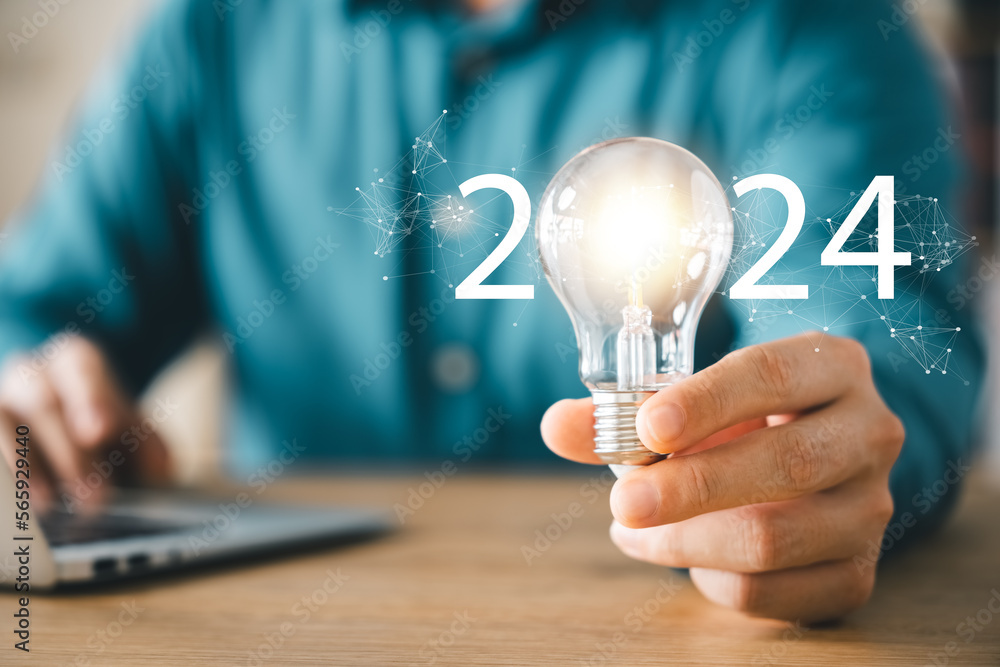 2024 creative concept, business man holding light bulb 2024 numbers