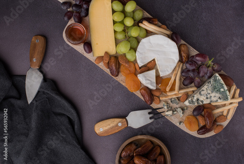 appetizer and cheese board, tapas with meat and fruits photo