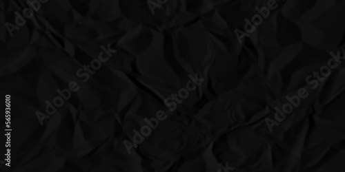Black crumpled paper texture background. A crumpled sheet of dark gray paper abstract background. 