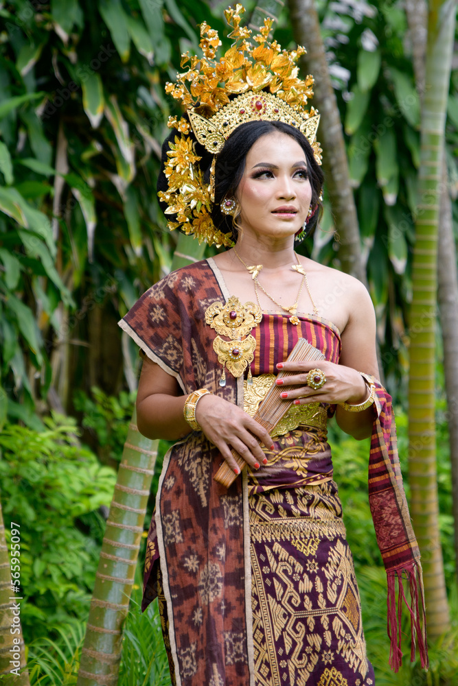 Portrait one female of the traditional clothing from bali called kebaya with a crown in her hair