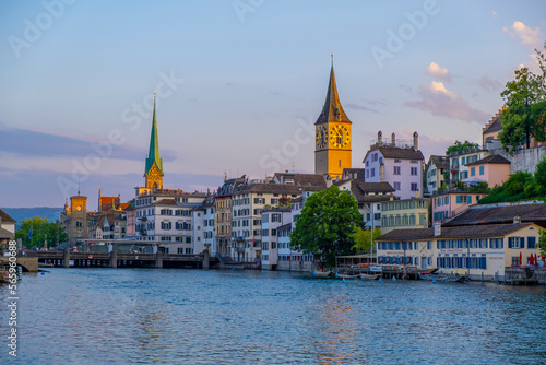 Scenic panoramic view of historic Z  rich city center with famous Fraum  nster and Grossm  nster Church and river Limmat at Lake Zurich on a beautiful sunny day with blue sky in summer  Switzerland