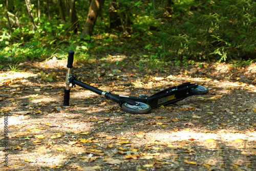 abandoned children's scooter in the woods