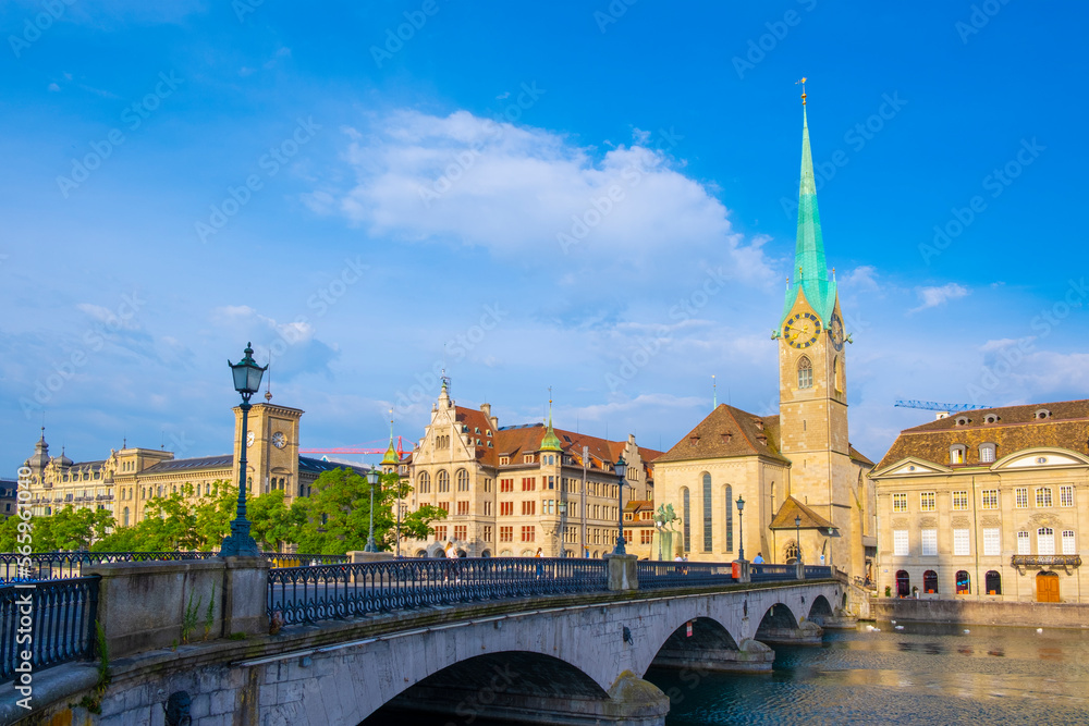 Scenic panoramic view of historic Zürich city center with famous Fraumünster and Grossmünster Church and river Limmat at Lake Zurich on a beautiful sunny day with blue sky in summer, Switzerland