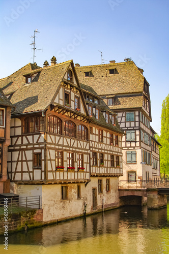 Ancient wood-framed traditional German French houses in Strasbourg at sunset colors, historical downtown of the city
