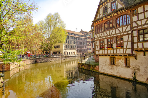 Ancient wood-framed traditional German French houses in Strasbourg at sunset colors, historical downtown of the city