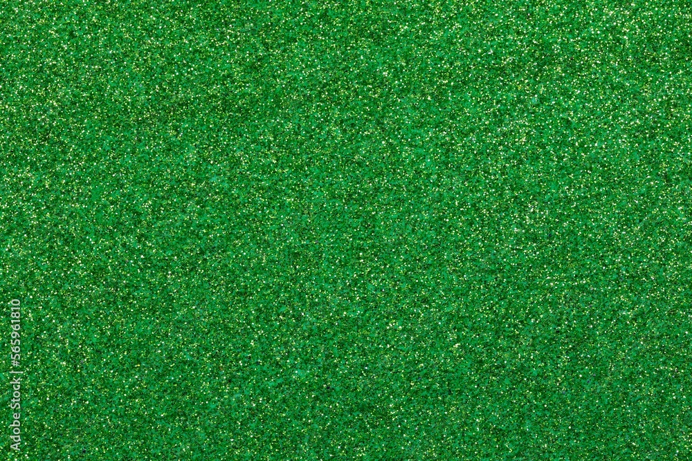 Fototapeta premium shimmering GREEN glitter material background with sparkles ideal as a lawn backdrop