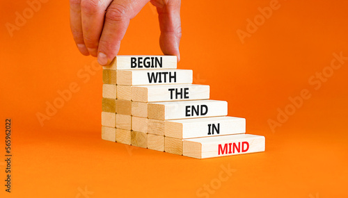 Begin in end of mind symbol. Concept words Begin with the end in mind on wooden blocks. Beautiful orange table orange background. Businessman hand. Business begin in end of mind concept. Copy space. photo
