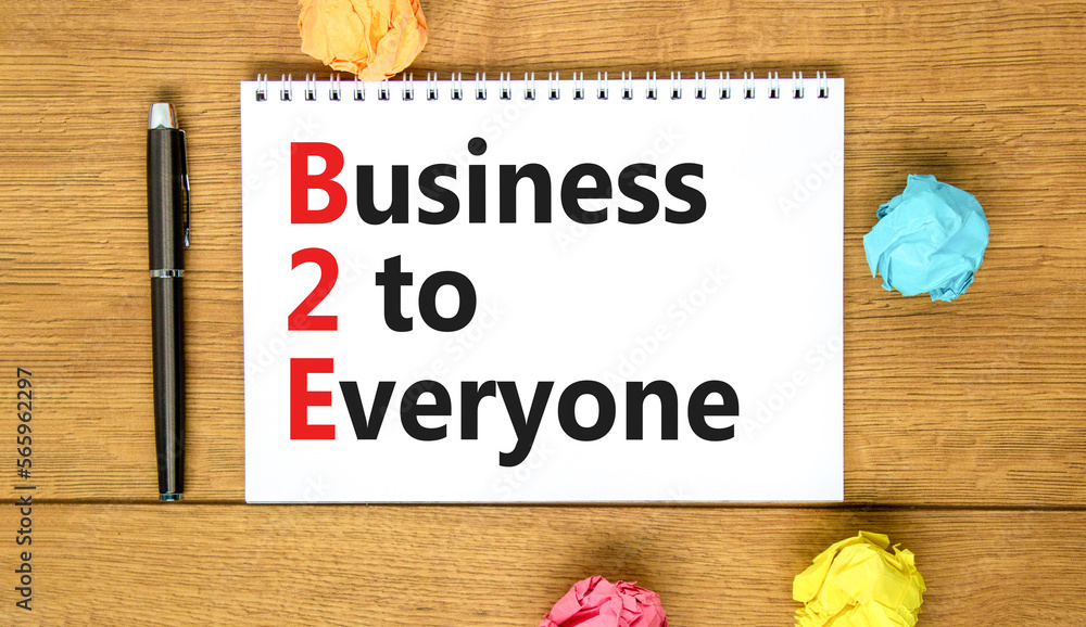 Fototapeta premium B2E business to everyone symbol. Concept words B2E business to everyone on white white note on a beautiful wooden background. Business and B2E business to everyone concept. Copy space.