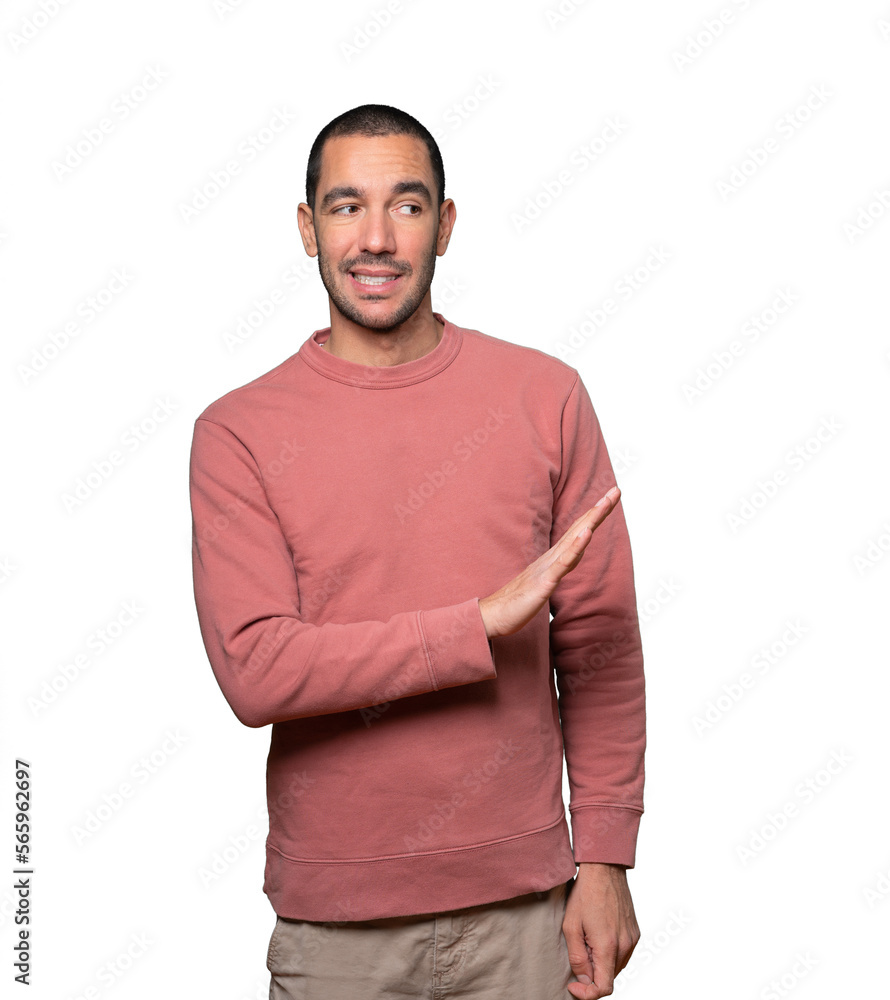 Doubtful young man doing a gesture of keep calm Doubtful young man doing a gesture of keep calm