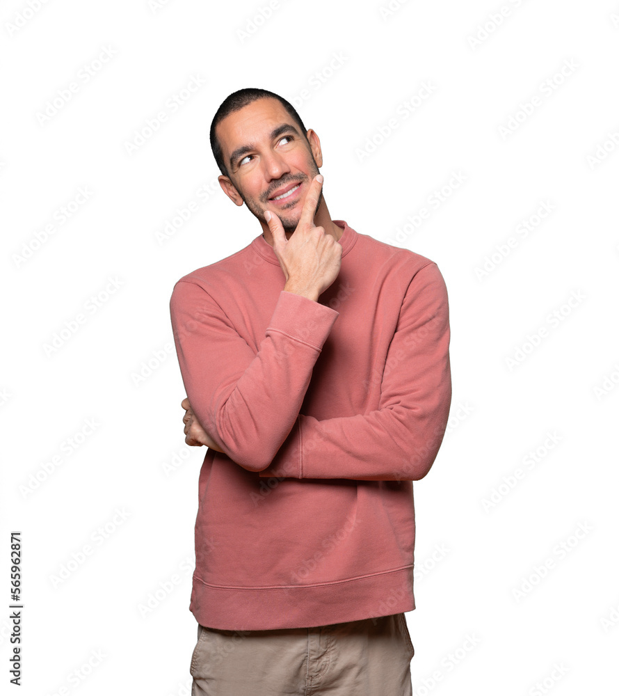 Happy young man making a gesture of doubt Happy young man making a gesture of doubt
