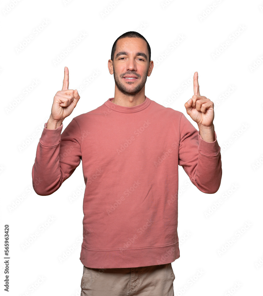 Happy young man pointing up with his finger Happy young man pointing up with his finger