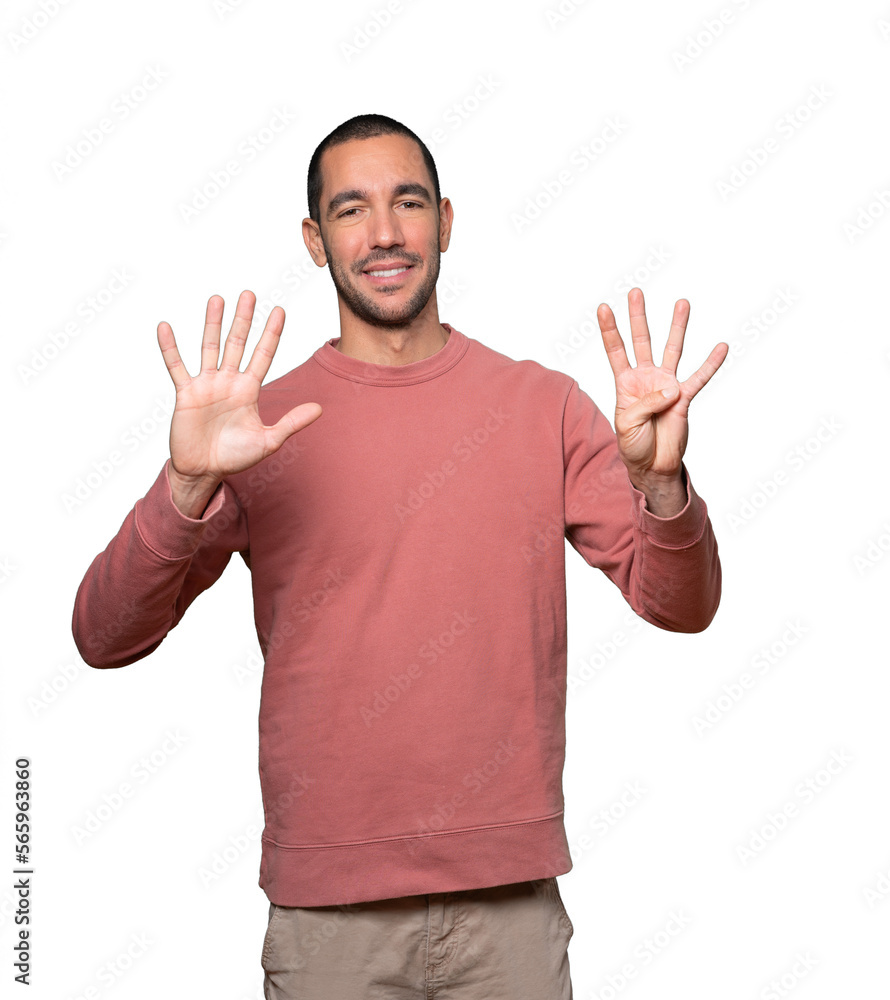 Happy young man doing a number nine gesture with his hands Happy young man doing a number nine gesture with his hands