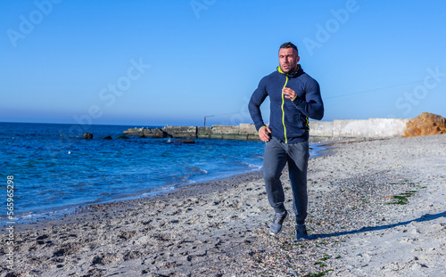 Male athlete doing sports on the beach