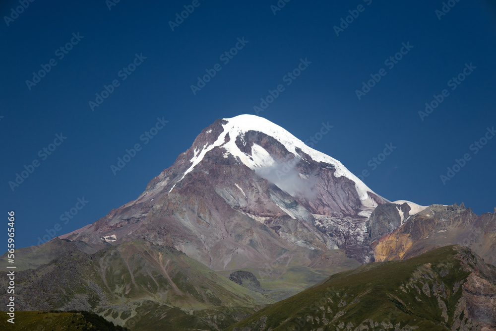 Mountain peak in the summer with snow on the top  in kazbegi, Georgia