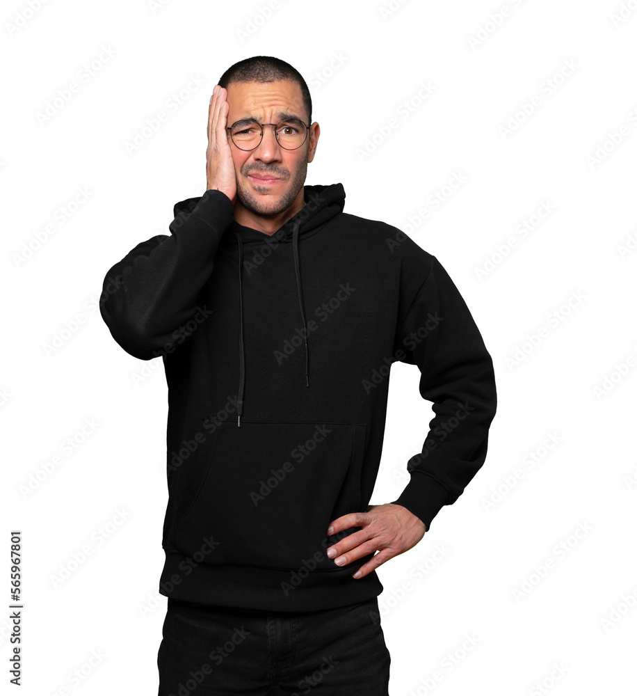 Concerned young man doing a gesture of relief Concerned young man doing a gesture of relief