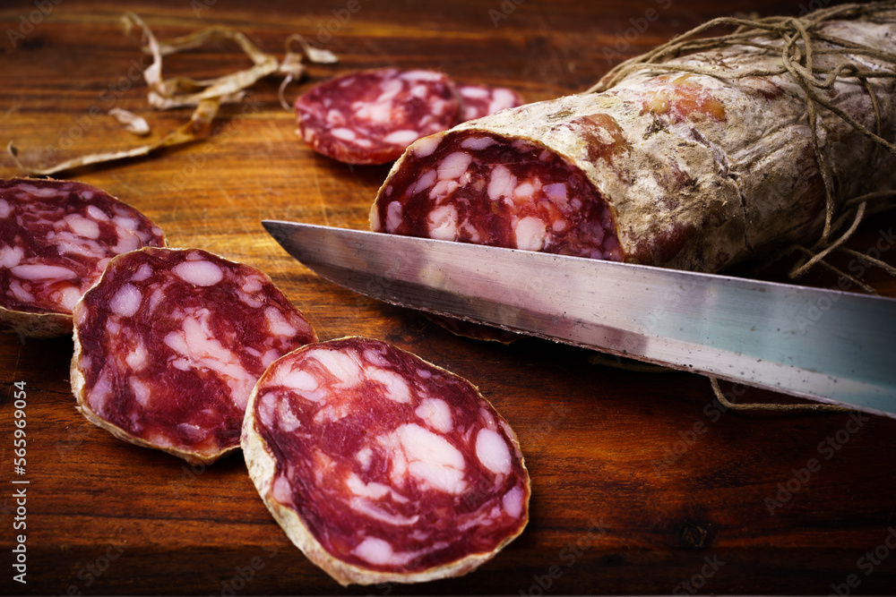 Piacenza salami cut on the wooden cutting board Piacenza salami cut on the wooden cutting board