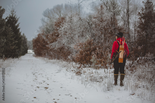 Young Man with Bow and quiver along wooded path photo