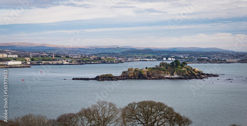 View across Plymouth Sound from Mount Edgecombe country park with Drake's Island in the foreground.