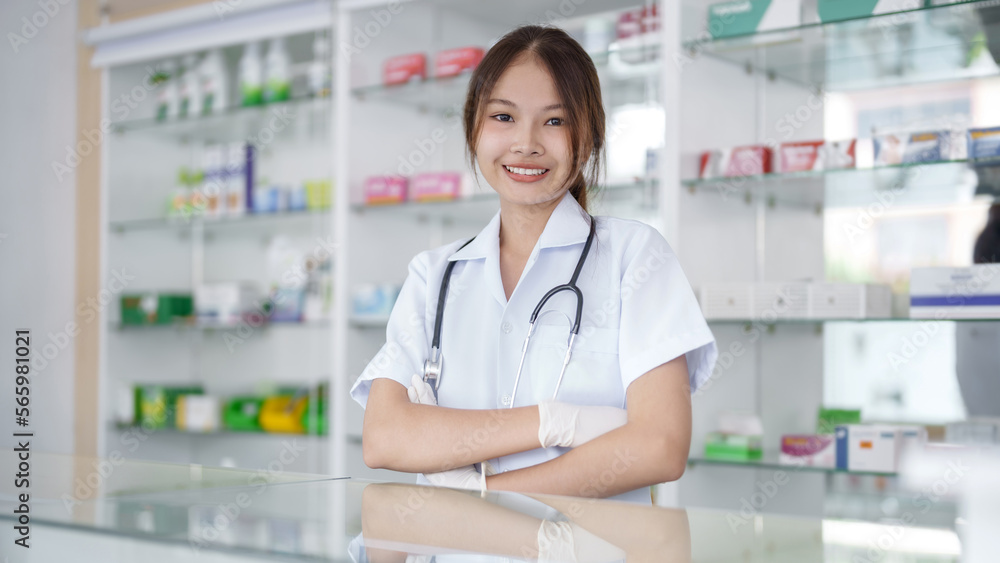 Portrait of asian pharmacist working in pharmacy with medication at pharmacy counter Portrait of asian pharmacist working in pharmacy with medication at pharmacy counter