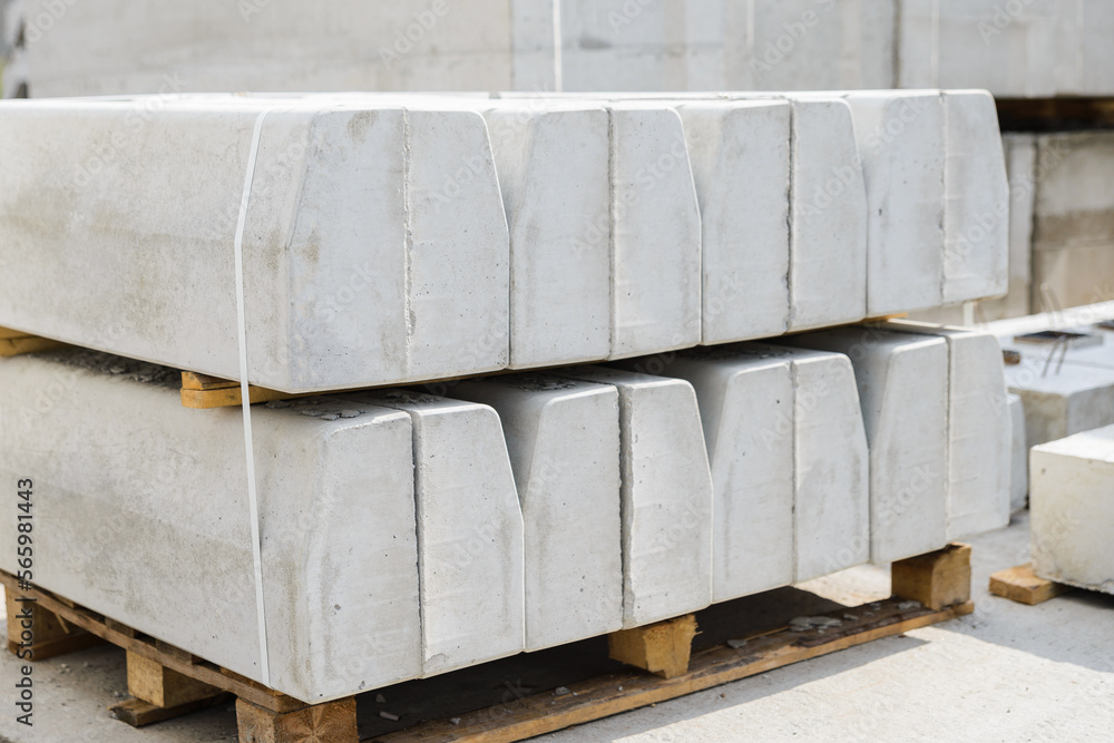 Close-up of concrete curbs in the warehouse of the precast concrete factory ready for shipment to the construction site. Close-up of concrete curbs in the warehouse of the precast concrete factory ready for shipment to the construction site.