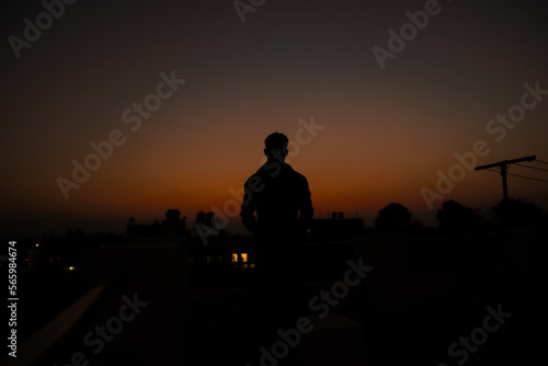 silhouette of a person standing on sunset 