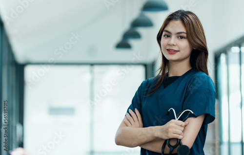 Portrait of young female doctor standing in hospital.