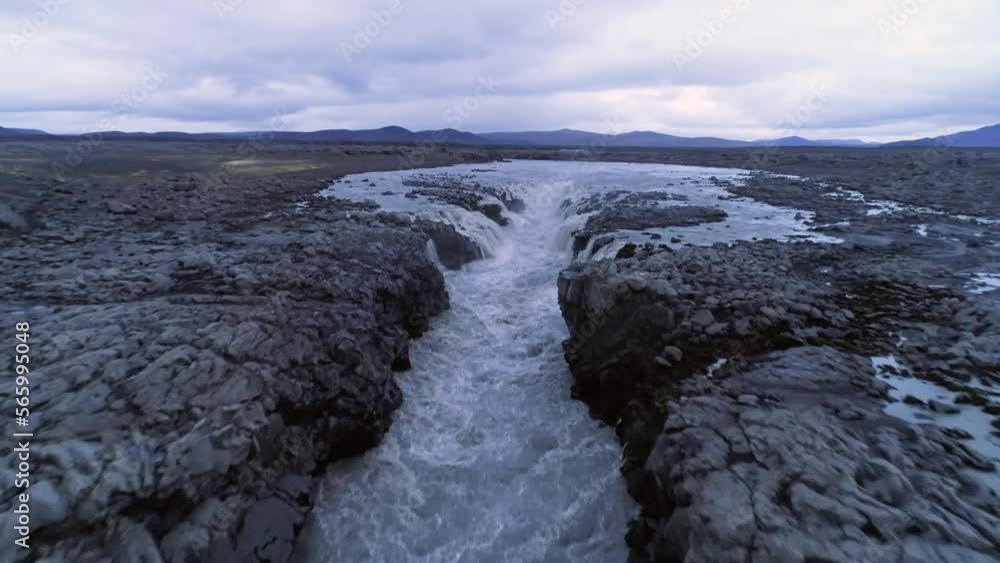 Aerial video of waterfall near Herðubreið in Iceland highlands at sunset, peaceful