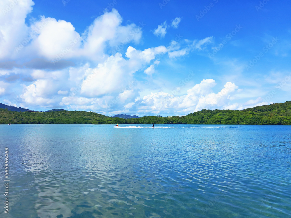 Aquatic sky in turquoise waters of the Caribbean sea. Tropical nature landscape of the French West Indies. Nautical sports.