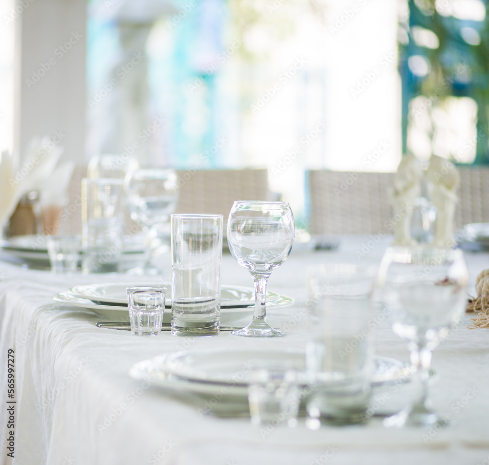 glass goblets on a festive white table glass goblets on a festive white table