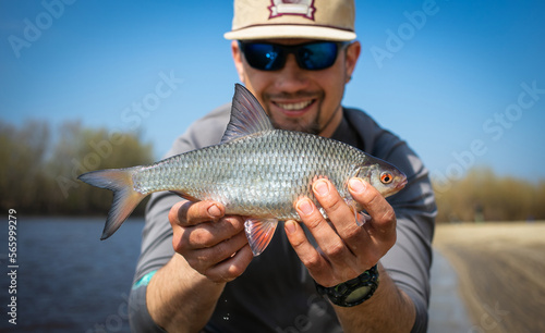Fishing. Fisherman and white fish roach. Blurred background. 
