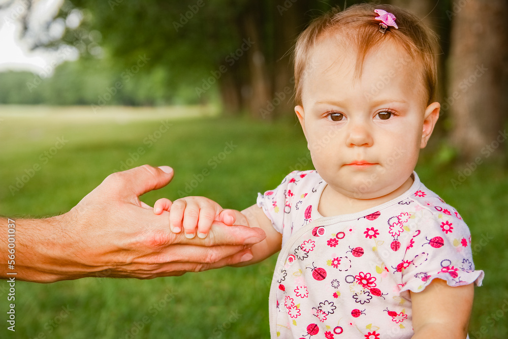 hands of a happy parent and child in nature hands of a happy parent and child in nature