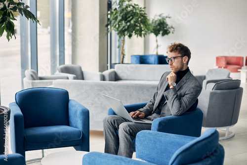 Young man in formal using laptop while waiting for a job interview. People and recruitment concept