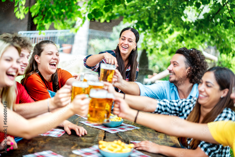 Young friends drinking and toasting beer at brewery bar restaurant - Beverage life style concept with happy guy and girls having fun together out side - Bright vivid filter with focus on mid woman Young friends drinking and toasting beer at brewery bar restaurant - Beverage life style concept with happy guy and girls having fun together out side - Bright vivid filter with focus on mid woman
