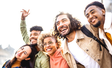 Trendy friends cheering together at out side location on life style concept - Happy guys and girls having fun walking around Barcelona streets - University students on travel vacation  - Bright filter