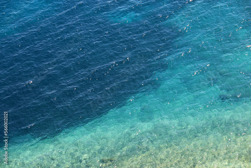 Azure water texture, transparent sea surface with a rocky bottom. Aerial view, natural turquoise background © Oleg