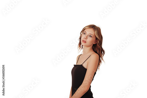 Portrait of slender teen girl model posing in black elegant dress isolated white background, looking away. Stylish teenager girl shooting in studio. Fashion style concept. Copy text space for ad