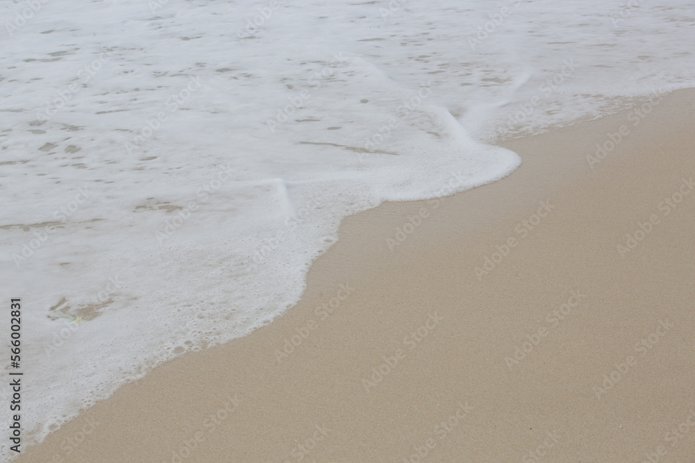 Foamy waves over sand on the tropical beach. Foamy waves over sand on the tropical beach.