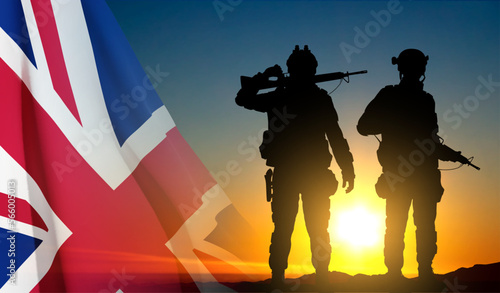 Silhouettes of a soldiers with United Kingdom flag on background of sky. Background for Remembrance Day. United Kingdom Armed Forces concept. EPS10 vector