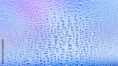 Water drops. Texture of the drops. Abstract gradient background. Cold rainbow gradient. Heavily textured image. Shallow depth of field. Selective focus
