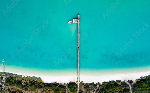 Vertical view of dock and empty beach from above