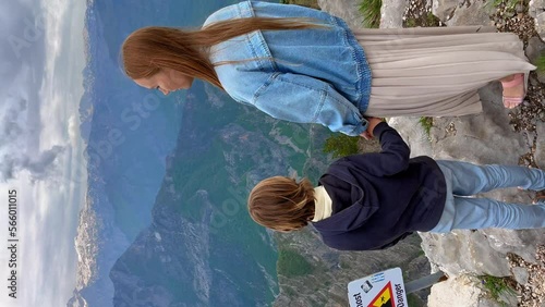 Vertical video. A young woman and her son tourists are visiting the Grlo Sokolovo canyon. A breathtaking sightseeing location in Montenegro photo