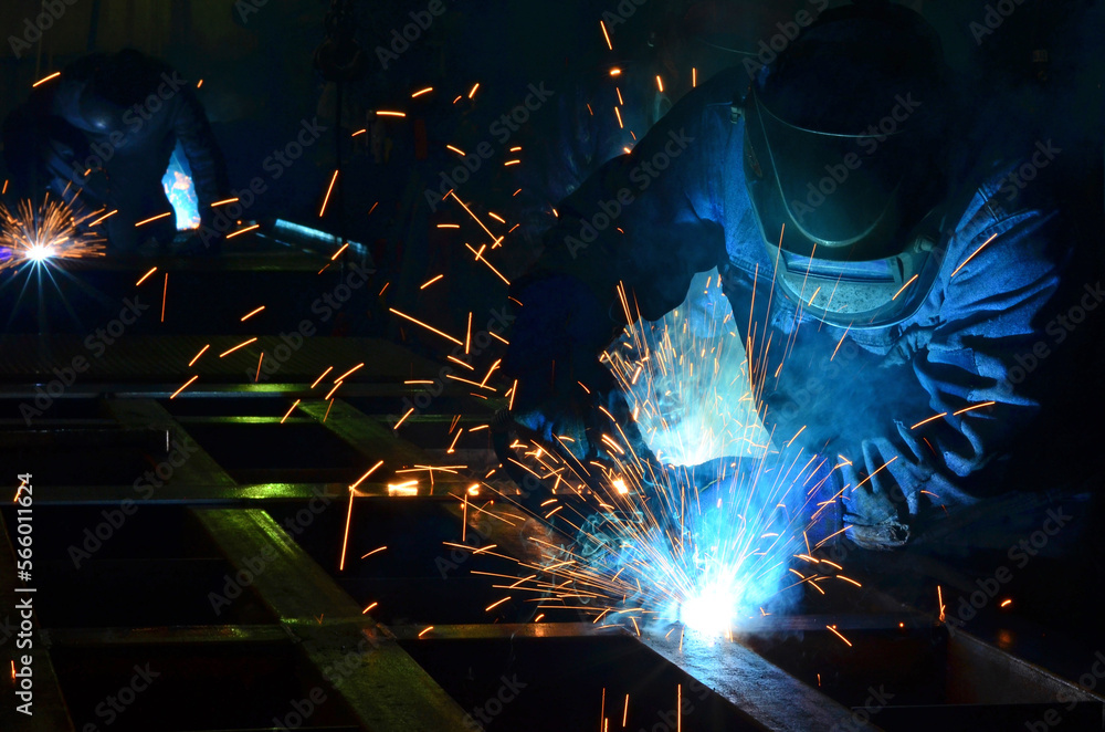 Workers wearing industrial uniforms and Welded Iron Mask at Steel welding plants, industrial safety first
Workers wearing industrial uniforms and Welded Iron Mask at Steel welding plants, industrial safety first