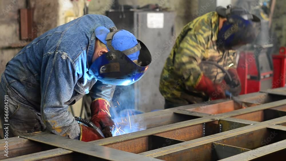 Workers wearing industrial uniforms and Welded Iron Mask at Steel welding plants, industrial safety first
Workers wearing industrial uniforms and Welded Iron Mask at Steel welding plants, industrial safety first