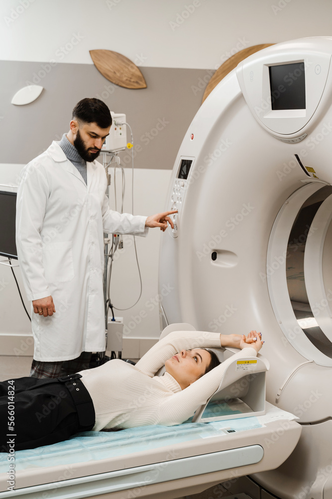 CT scan of abdomen of girl in medical clinic. Woman patient is doing computed tomography x-ray scan chest examination of abdominal in a CT scan room. CT scan of abdomen of girl in medical clinic. Woman patient is doing computed tomography x-ray scan chest examination of abdominal in a CT scan room.
