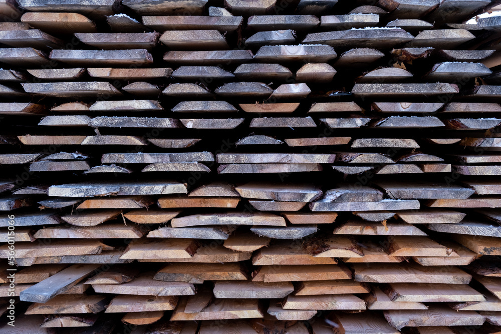 A stack of processed boards stands on the street in winter A stack of processed boards stands on the street in winter